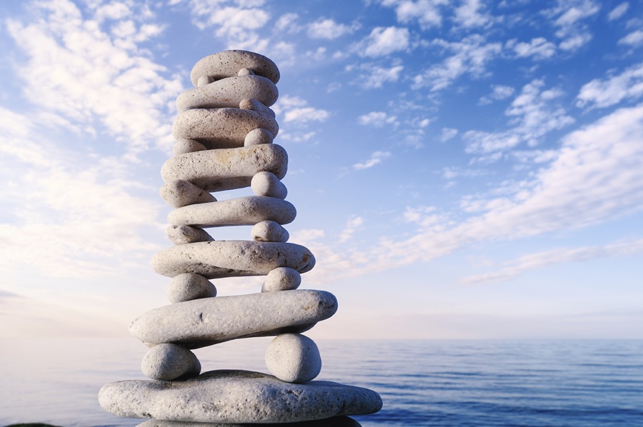 Stack of balanced stones with water background