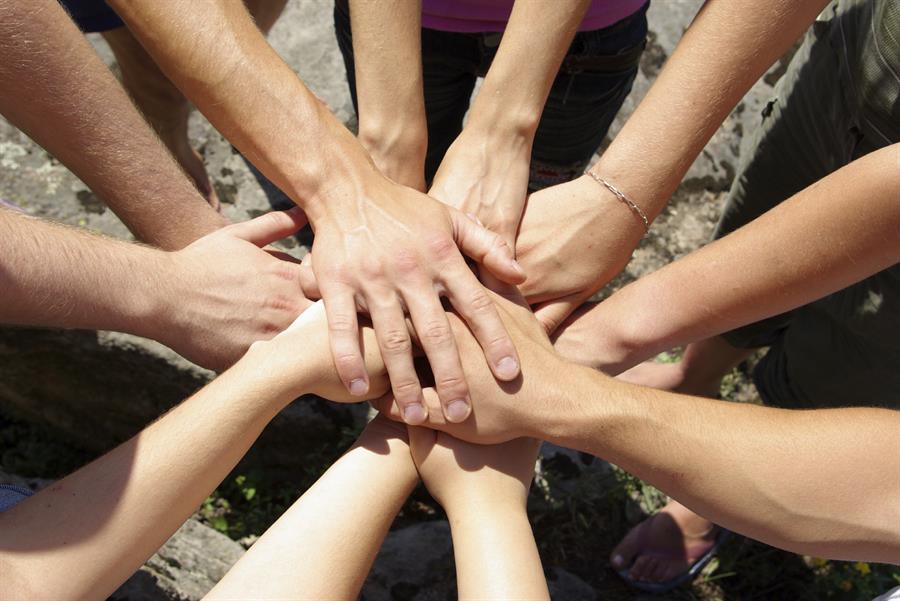 hands reaching in together in a circle