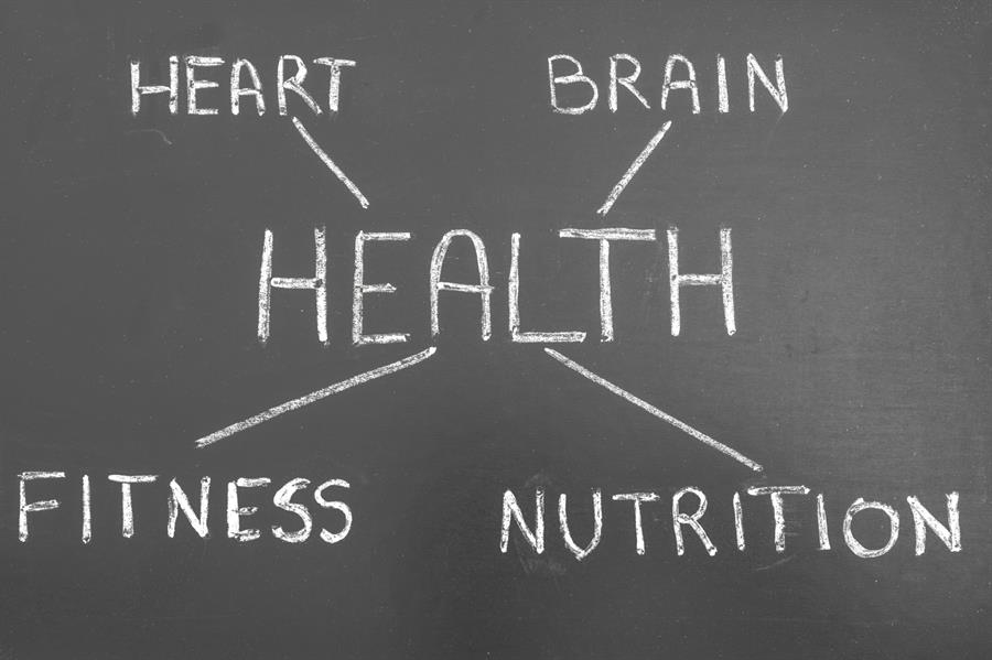 Chalkboard with word health in the centre and words heart, brain, fitness and nutrition surrounding