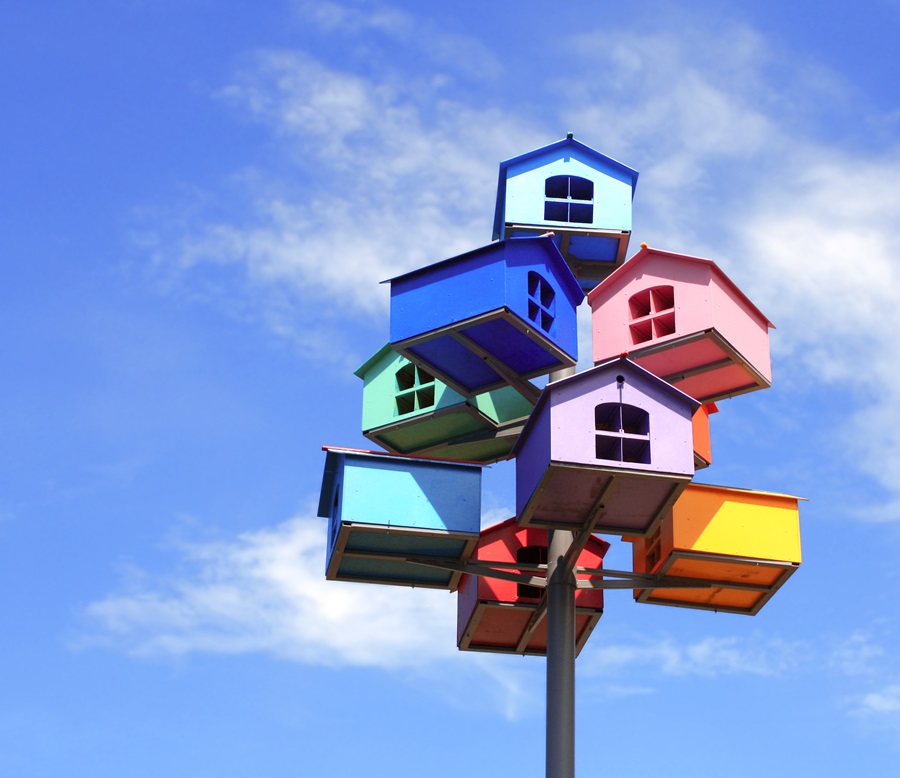 colourful bird houses on a post