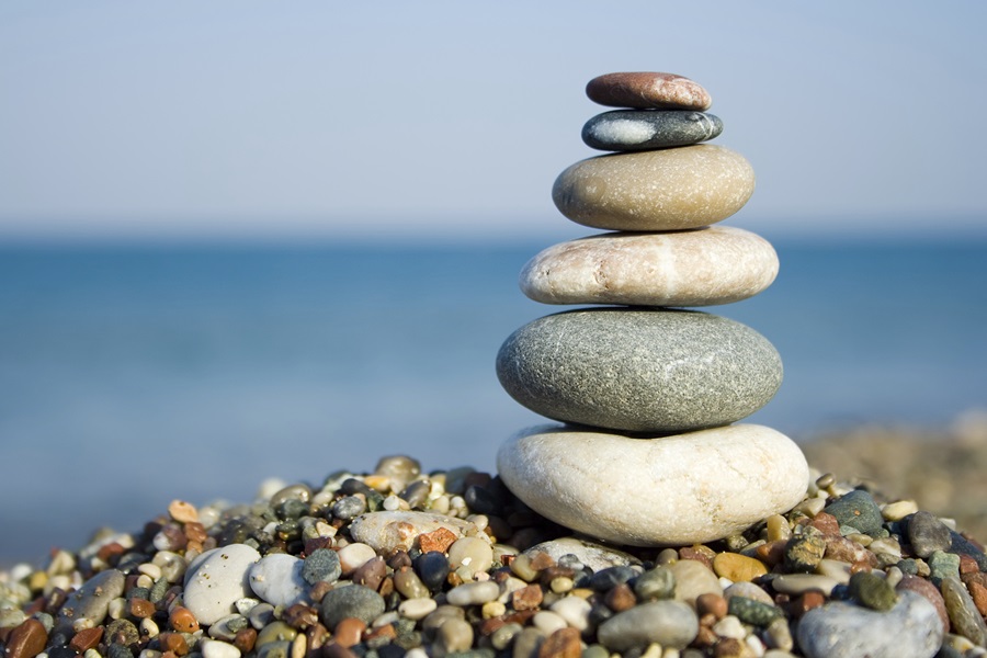 stack of smooth stones with water in background