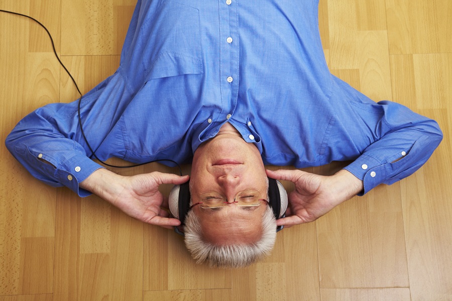 Man listening to headphones with eyes closed