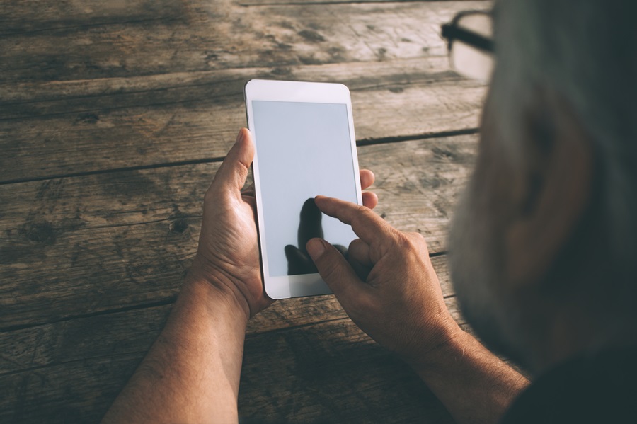 overhead shot of senior man using tablet