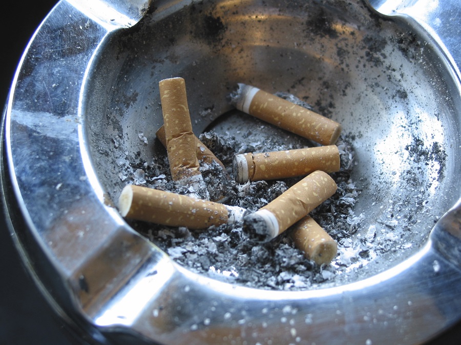 cigarette butts extinguished in a metal ash tray